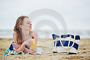 Woman relaxing and sunbathing on beach