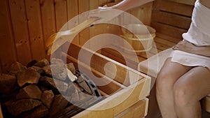 Woman relaxing and sweating in hot sauna