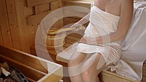 Woman relaxing and sweating in hot sauna