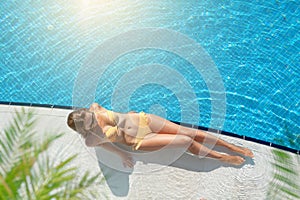 Woman relaxing at swimming pool