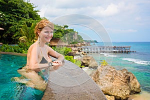 Woman relaxing in swimming pool on tropical vacation