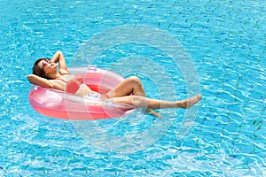 woman relaxing in swimming pool