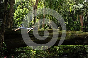 Woman relaxing in a tropical forest