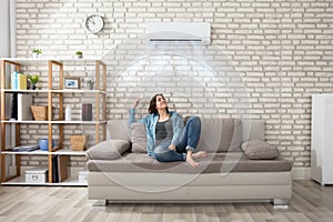 Woman Relaxing Under The Air Conditioner