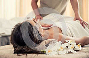 Woman relaxing under the therapeutic effect of a crystal placed