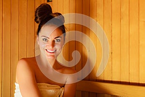 Woman relaxing in wooden sauna room