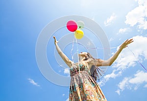 Woman releasing balloons