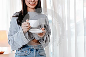 Woman relxing time while working and hold cup of coffee at working place