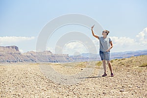 Woman in a remote location holding up mobile phone trying to get a signal
