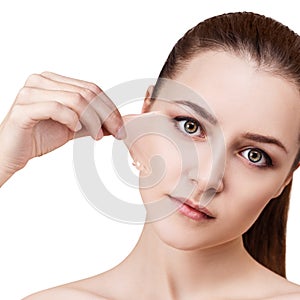 Woman remove her old dry skin from face.