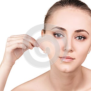 Woman remove her old dry skin from face.