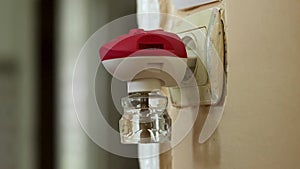 Woman remove the plugs electric liquid mosquito repeller from the outlet close-up