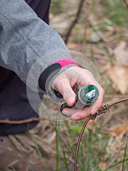 Woman  removes list from Geocaching ampoule