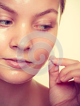 Woman removing facial peel off mask