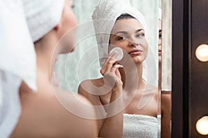 Woman removing makeup photo