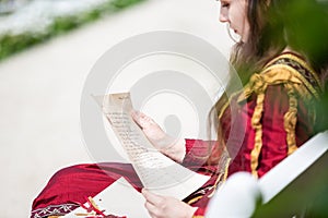 Woman in renaissance dress reading a letter