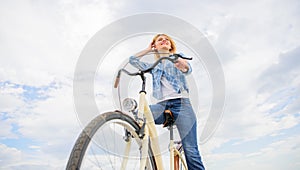 Woman rent bike to explore city copy space. Girl rides bike sky background. Bike rental shops primarily serve people who