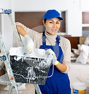 Woman repair worker inside apartment