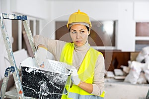 Woman repair worker inside apartment