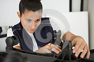 woman repairing chair by hand with removable castors