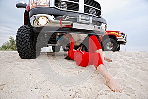 woman repairing the red jeep