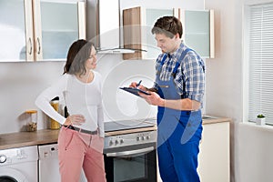 Woman And Repairman In Kitchen
