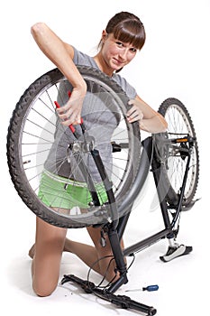 Woman repairs bicycle