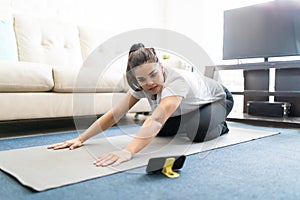 Woman repeating yoga exercise from online videos