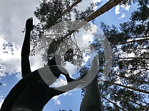 A woman representing victory floats into the clouds photo