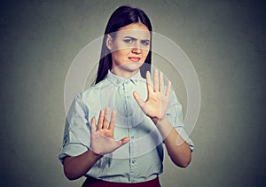 Woman repulsing something with hands stop gesture