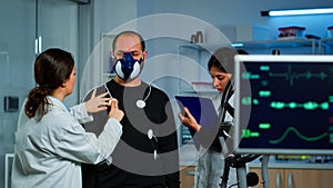 Woman researcher preparing patient for endurance test