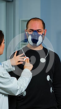 Woman researcher preparing patient for endurance test