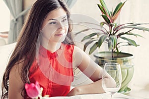 A woman in a restaurant is drinking cocktail