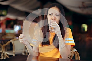 Woman in a Restaurant Fighting Heat Waves with a Fan