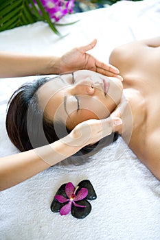 Woman restful while having a facial therapy