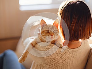 woman resting with cat on sofa at home