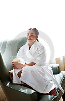 Woman resting in chair with eyes closed.