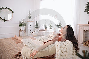 Woman resting in comfortable papasan chair at home