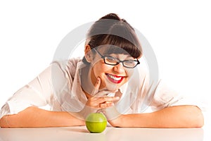 Woman resting on desk in glasses with apple