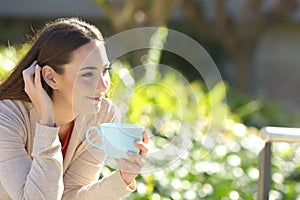 Woman resting and drinking coffee in a park