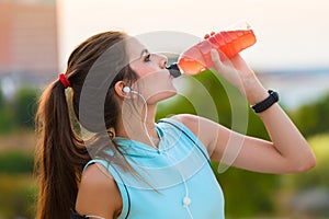 Woman resting and drinking after running