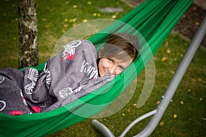 Woman resting in green hammock