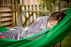 Woman resting in green hammock