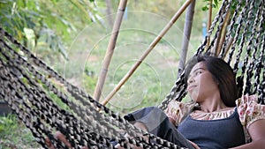 Woman resting on a Hammock swing  Made from fabric in garden