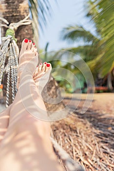 Woman Resting in a Hammock on a Tropical Background. Sea and Rest. Journey. Holiday