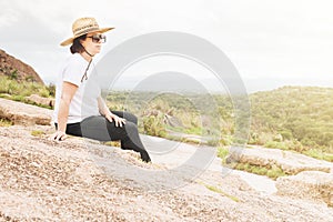 Woman Resting Happily on a Rock Outcropping photo