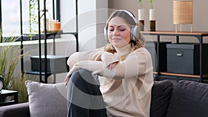 Woman Resting At Home And Listening Music In Headphones