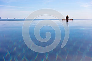 Woman Resting In Infinity Pool At a Aonang Beach Resort