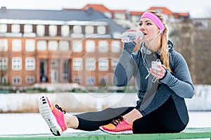 Woman resting from jogging or sport on winter day