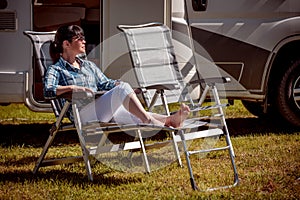 Woman resting near motorhomes in nature. Family vacation travel, holiday trip in motorhome RV, Caravan car Vacation.